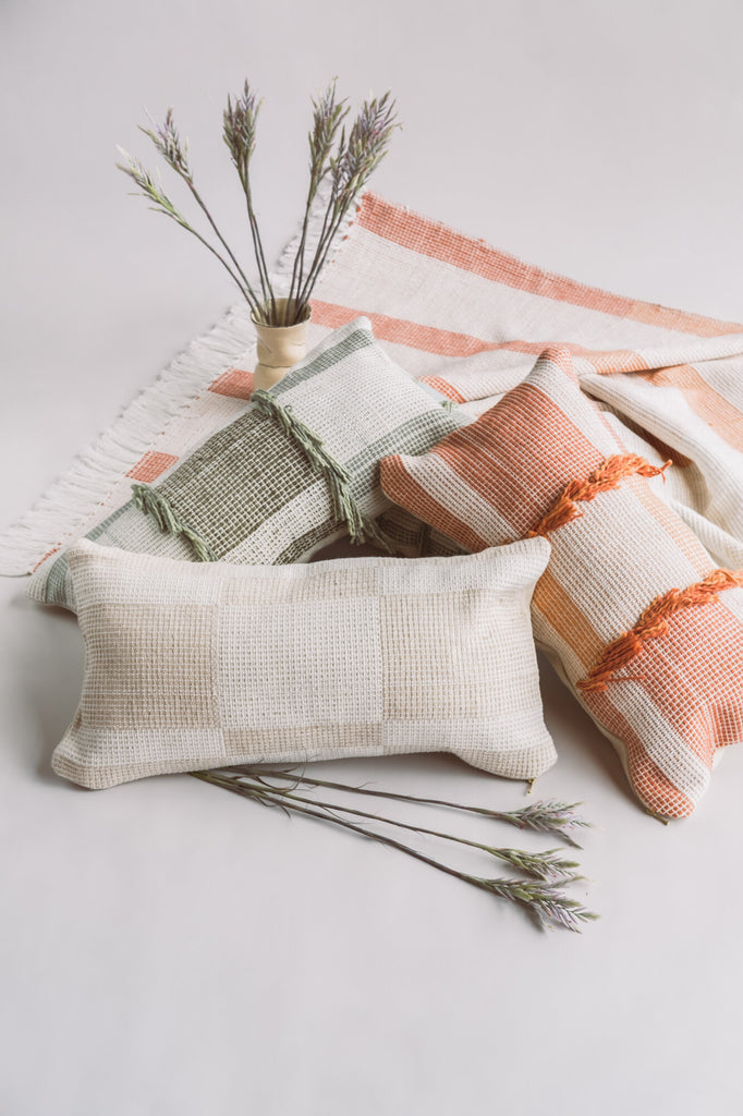 Handcrafted artisanal throw pillows, adding warmth and style to the living room decor.